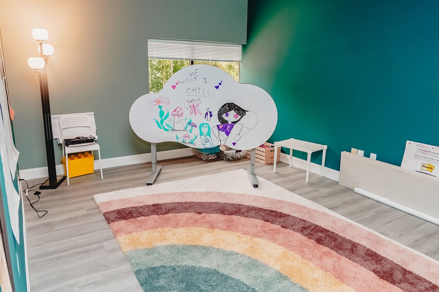 Calm sensory room with a rainbow arch and swing at Prana Play in Carmel, Indiana