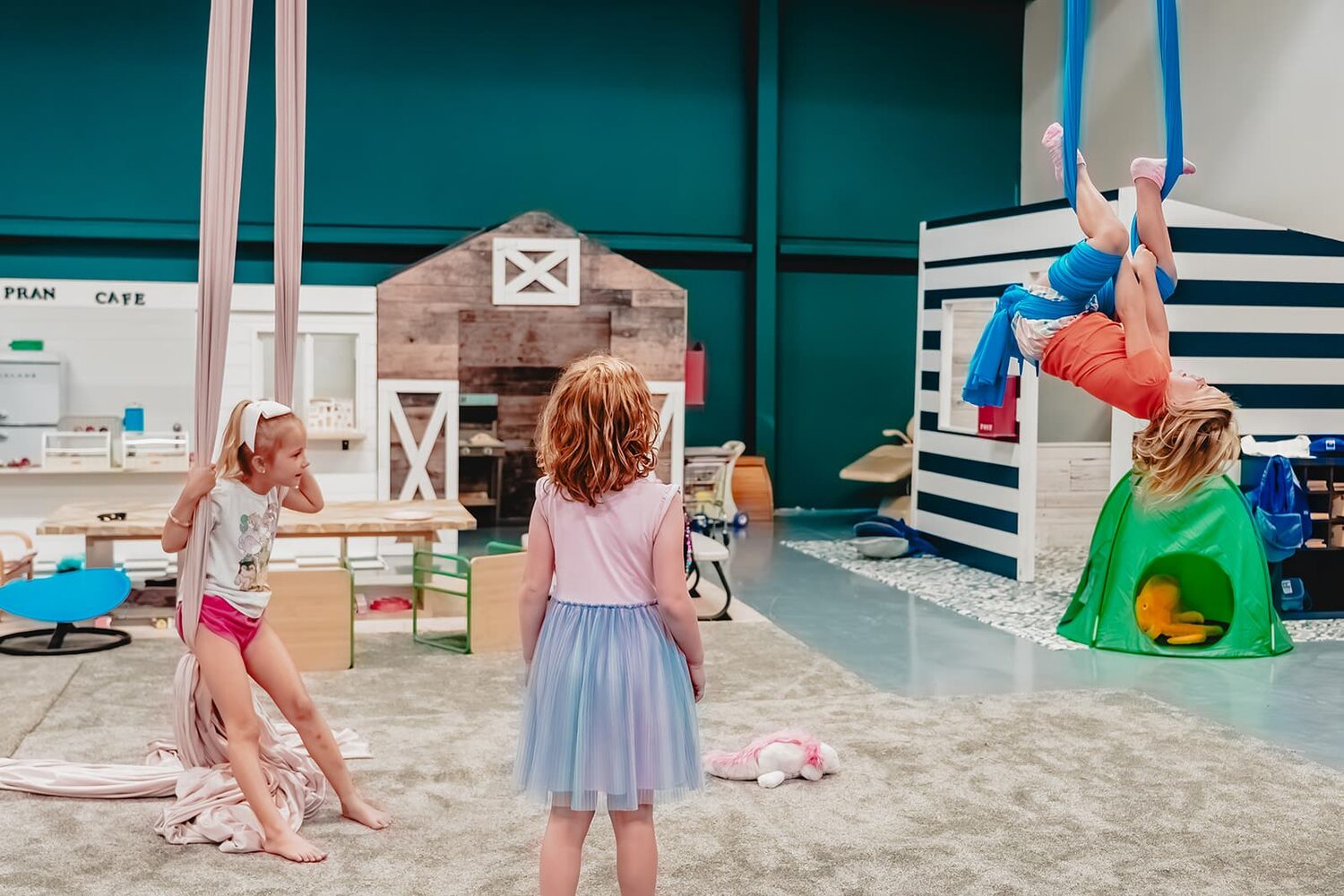 Children in the pretend-play barn at Prana Play