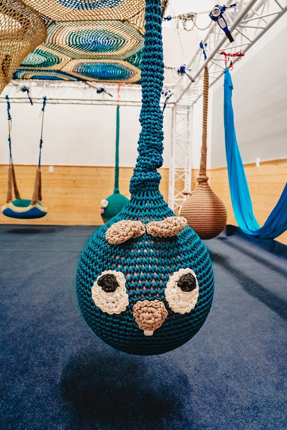 A child smiling in the ball pit